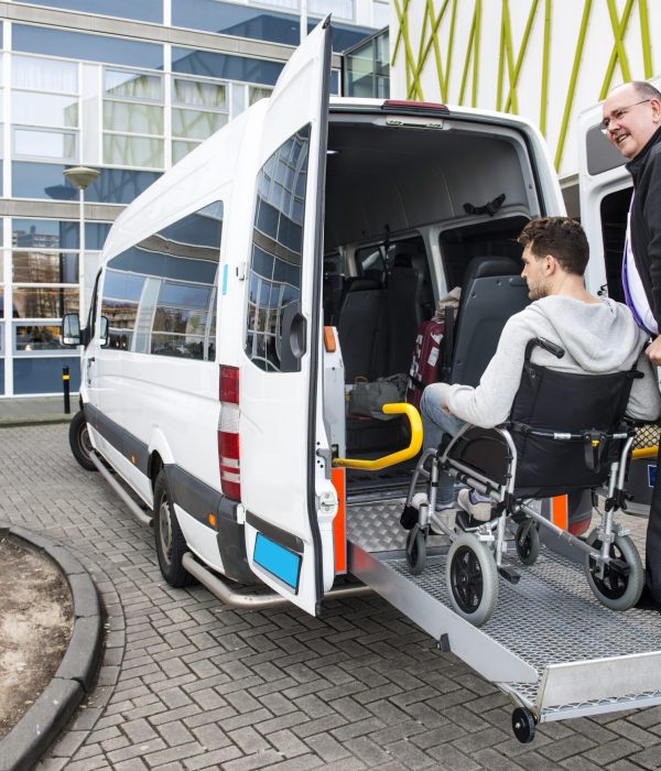 The,Driver,Of,A,Wheel,Chair,Taxi,,Helping,A,Disabled